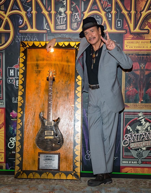 Santana receives a commemorative guitar for the 100,000th ticket sold to his show in House of Blues at Mandalay Bay